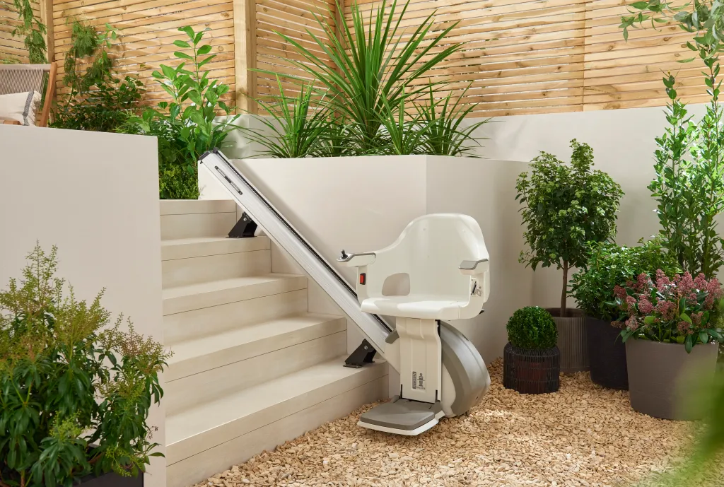 A stairlift installed on a wooden staircase in a home.