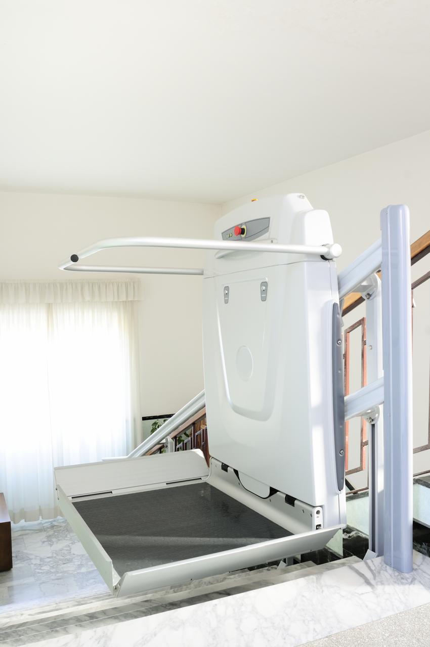 A platform lift with glass walls in a public building.