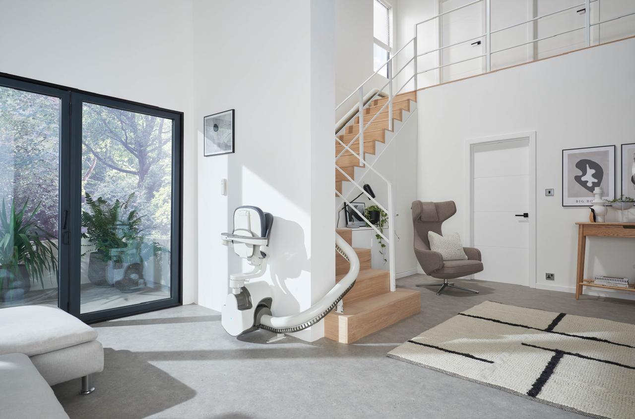 A stairlift installed on a wooden staircase in a home.